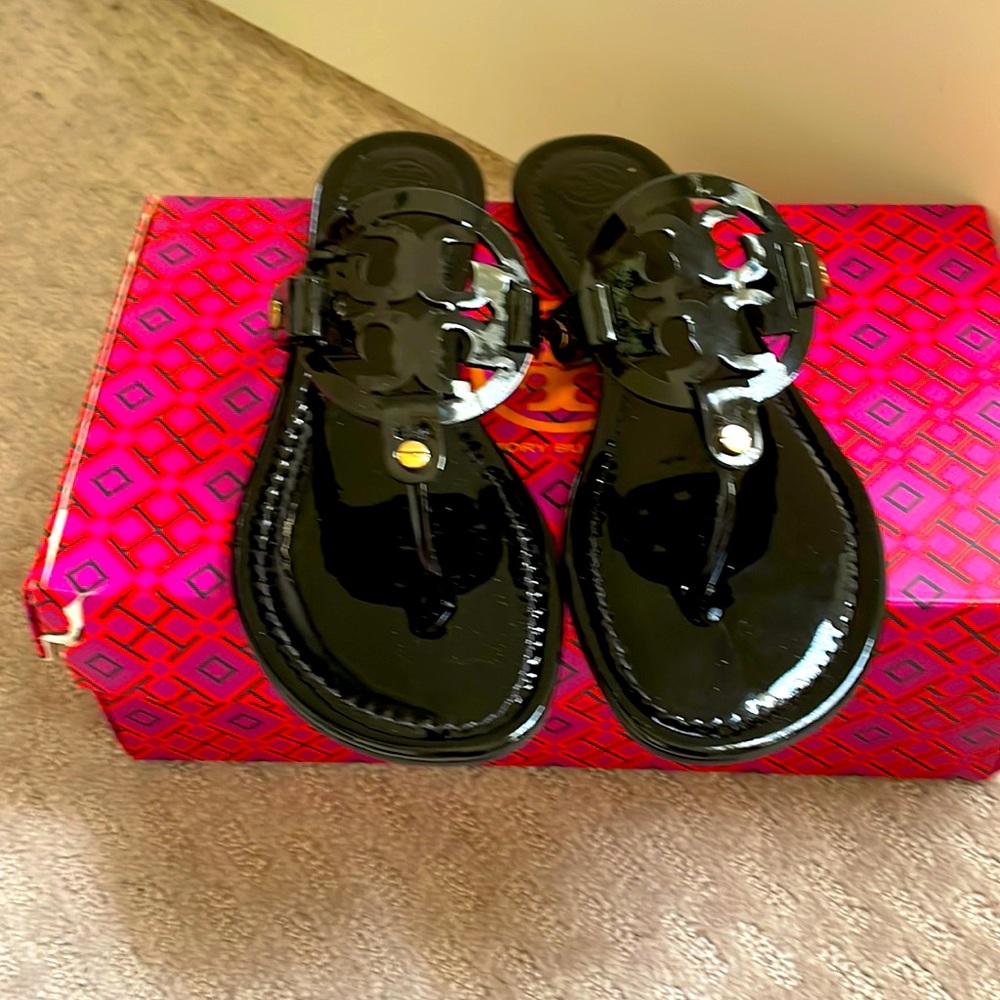 Black patent leather sandals w gold accents. These are brand new